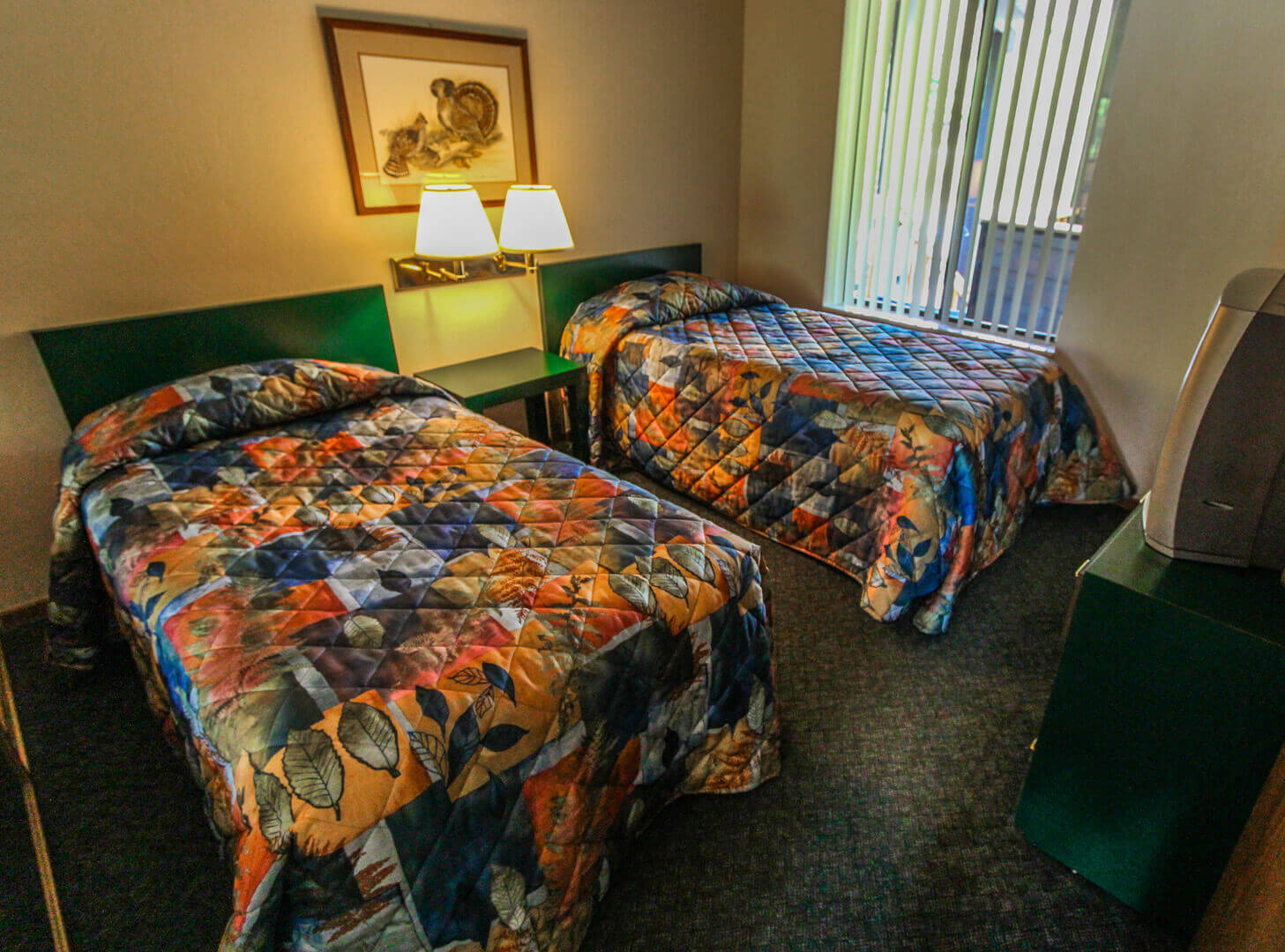 A spacious bedroom with double beds at VRI's Wolf Creek Village I in Eden, Utah.